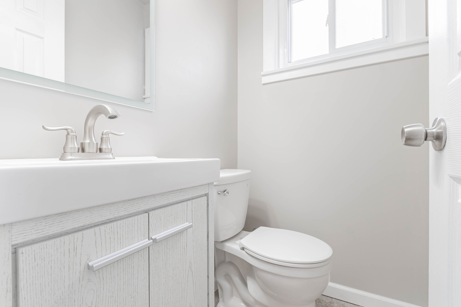 9515 Sumac Road, Unit F Des Plaines, IL 60016 - Photo 9 of 25 a bathroom with a sink a toilet and a mirror