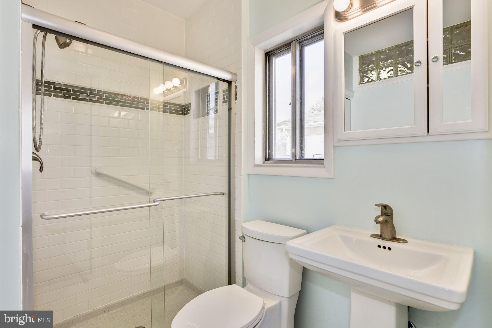 4614 Hawksbury Road Baltimore, MD 21208 - Photo 15 of 33 a bathroom with a sink toilet and shower