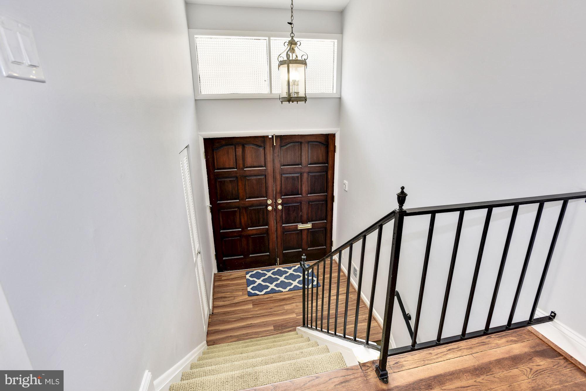 4614 Hawksbury Road Baltimore, MD 21208 - Photo 21 of 33 a view of a hallway with wooden floor and staircase