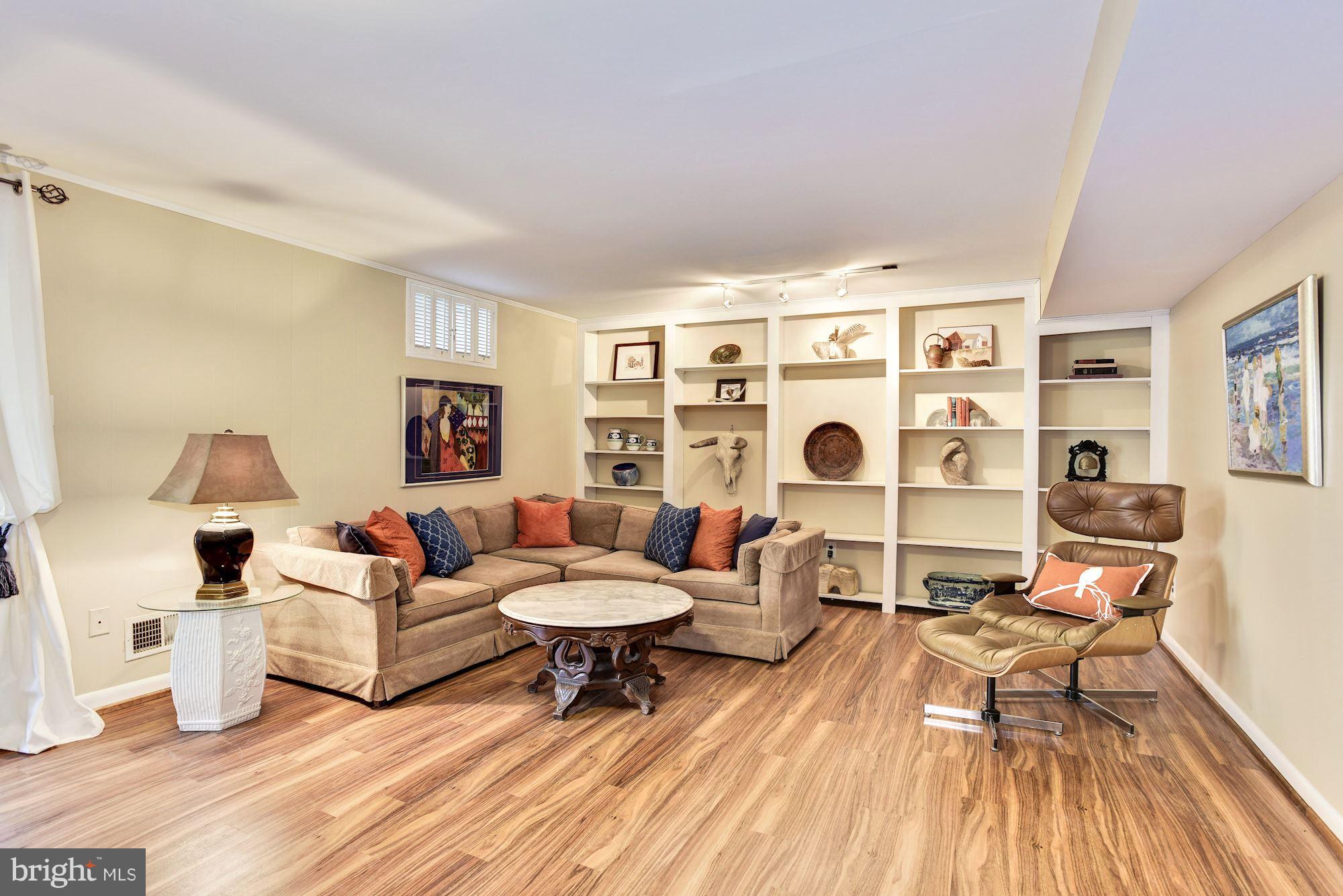 4614 Hawksbury Road Baltimore, MD 21208 - Photo 22 of 33 a living room with furniture and a wooden floor