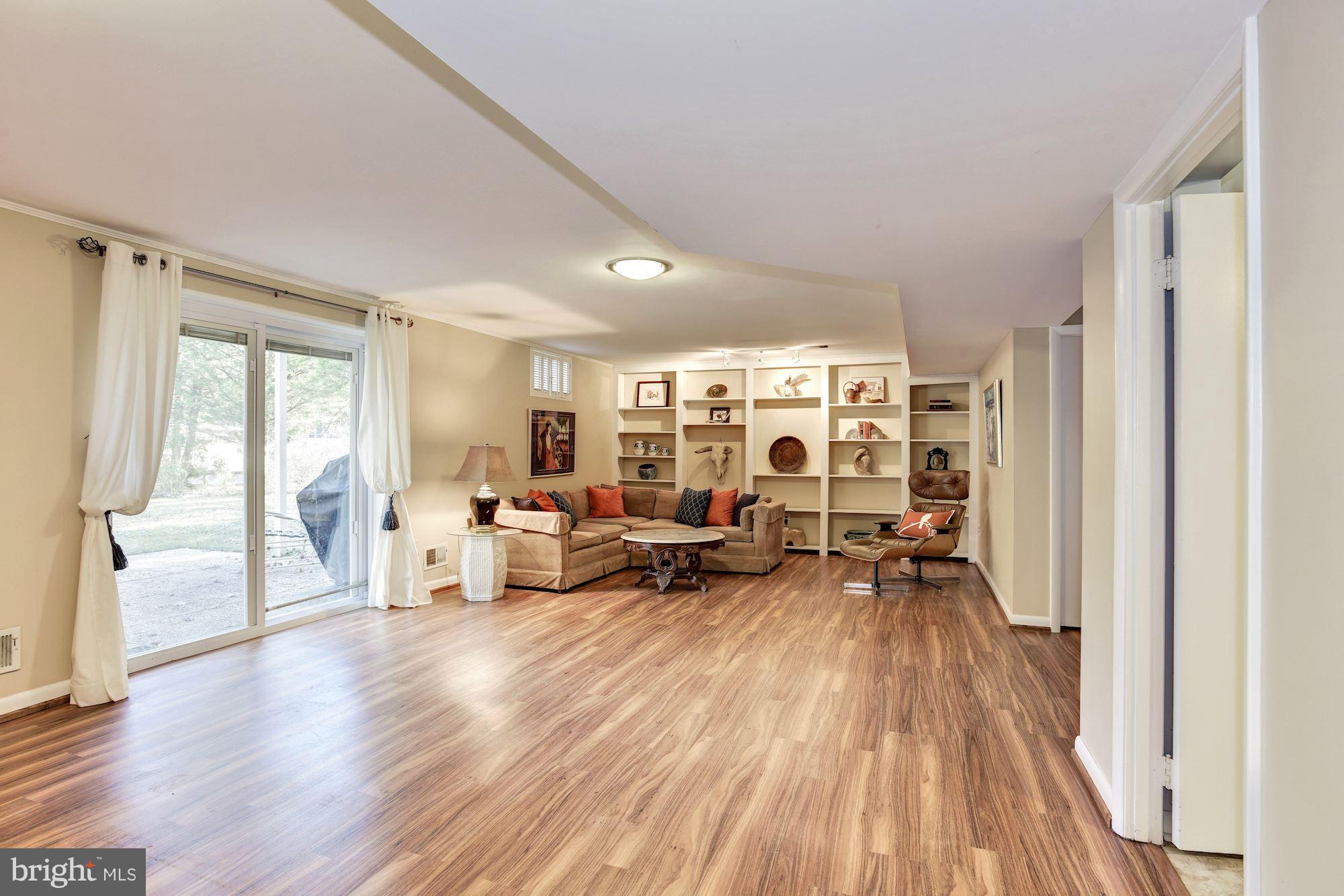 4614 Hawksbury Road Baltimore, MD 21208 - Photo 23 of 33 a living room with furniture and a wooden floor