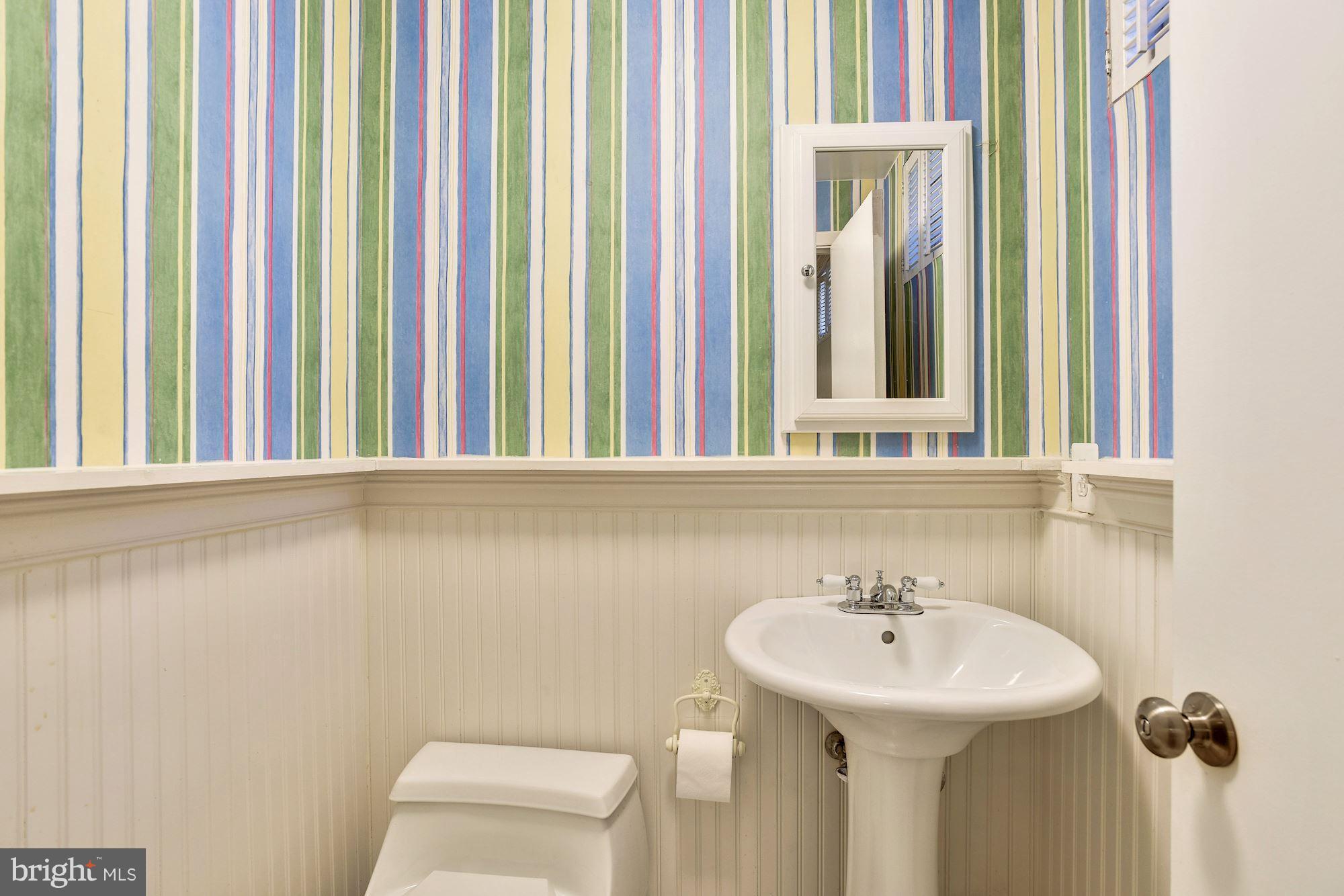 4614 Hawksbury Road Baltimore, MD 21208 - Photo 28 of 33 a bathroom with a sink a toilet and a mirror