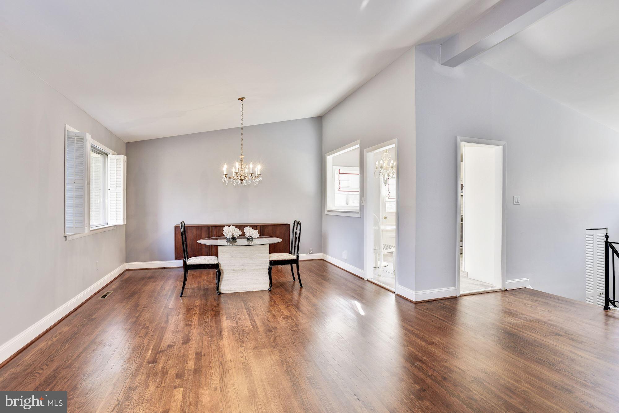 4614 Hawksbury Road Baltimore, MD 21208 - Photo 4 of 33 an empty room with wooden floor and windows