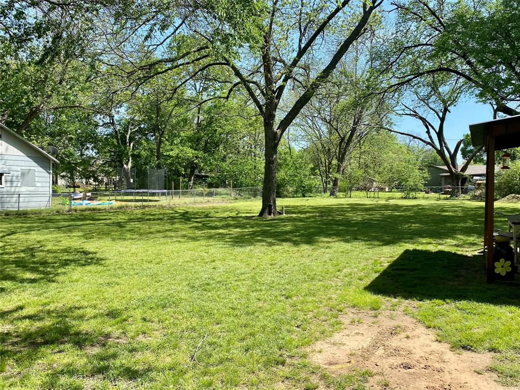 1115 South 6th Street Bonham, TX 75418 - Photo 16 of 23 a view of a grassy field with trees