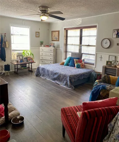 a bedroom with furniture and a large window