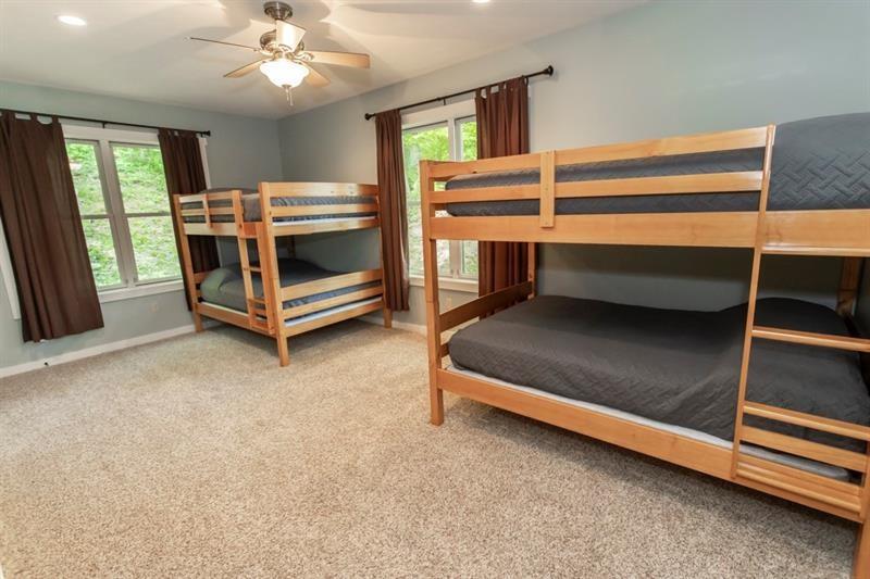 2226 County Line Road Champion, PA 15622 - Photo 17 of 33 a bedroom with a bunk bed and a chandelier