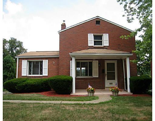 933 Roland Road Pittsburgh, PA 15221 - Photo 1 of 13 a front view of a house with garden
