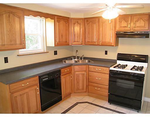 933 Roland Road Pittsburgh, PA 15221 - Photo 2 of 13 a kitchen with stainless steel appliances granite countertop a stove a sink and a microwave