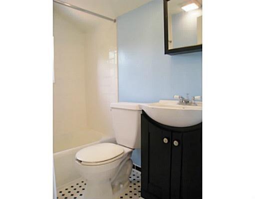 933 Roland Road Pittsburgh, PA 15221 - Photo 7 of 13 a bathroom with a sink a toilet and mirror