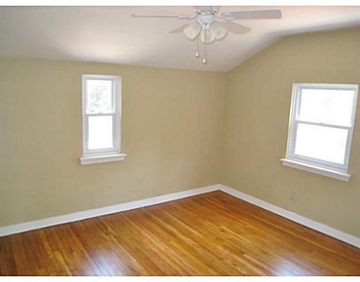 933 Roland Road Pittsburgh, PA 15221 - Photo 8 of 13 a view of empty room with wooden floor and fan