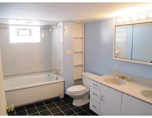 933 Roland Road Pittsburgh, PA 15221 - Photo 10 of 13 a bathroom with a bathtub shower sink mirror vanity and a toilet