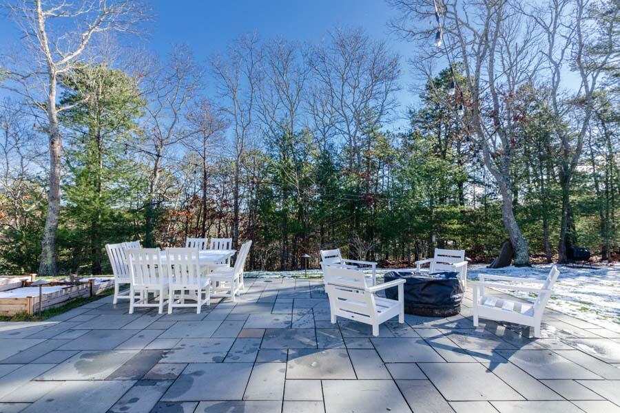 31 Captain Carleton's Road Cotuit, MA 02635 - Photo 12 of 32 a view of a patio with chairs and potted plants