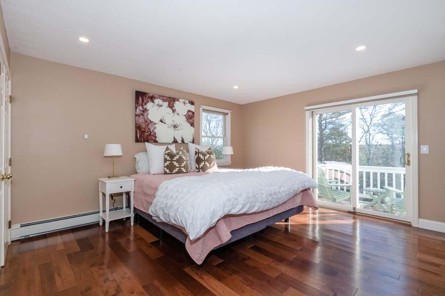 31 Captain Carleton's Road Cotuit, MA 02635 - Photo 14 of 32 a bedroom with a large bed and a large window