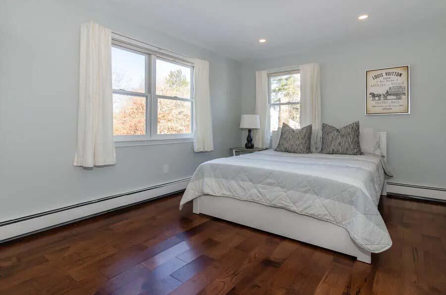 31 Captain Carleton's Road Cotuit, MA 02635 - Photo 15 of 32 a bedroom with a bed and wooden floor