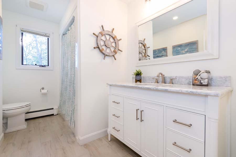 31 Captain Carleton's Road Cotuit, MA 02635 - Photo 17 of 32 a bathroom with a sink a toilet and a mirror