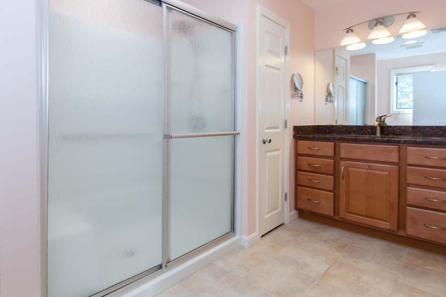 31 Captain Carleton's Road Cotuit, MA 02635 - Photo 18 of 32 a bathroom with a double vanity sink and a mirror