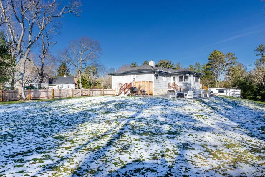 31 Captain Carleton's Road Cotuit, MA 02635 - Photo 26 of 32 a view of a yard with a house in the background
