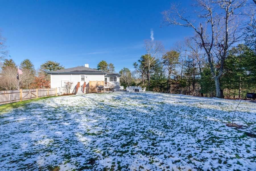 31 Captain Carleton's Road Cotuit, MA 02635 - Photo 27 of 32 a view of a yard with a house in the background