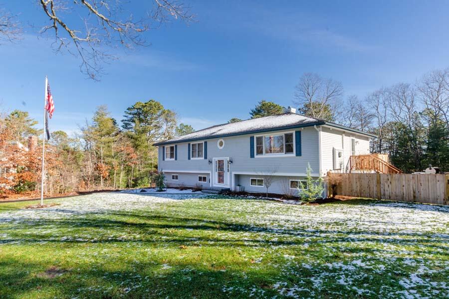31 Captain Carleton's Road Cotuit, MA 02635 - Photo 30 of 32 a front view of a house with a yard