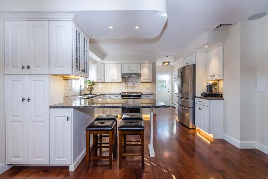 31 Captain Carleton's Road Cotuit, MA 02635 - Photo 5 of 32 a kitchen with stainless steel appliances granite countertop a stove refrigerator and a view of living room