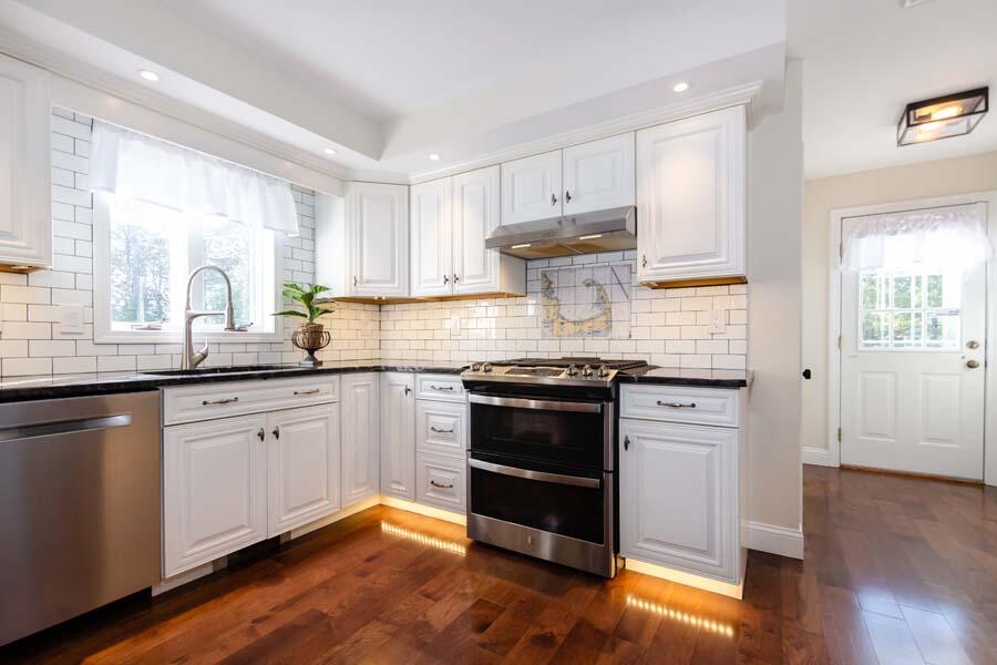 31 Captain Carleton's Road Cotuit, MA 02635 - Photo 6 of 32 a kitchen with granite countertop white cabinets and appliances
