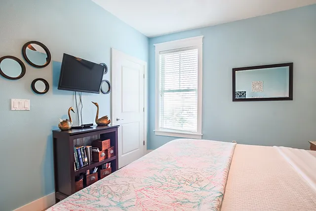 a bedroom with a bed and a flat screen tv