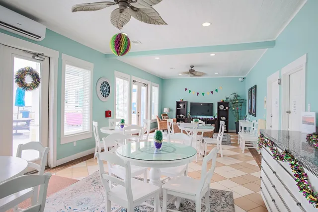 a living room with furniture a chandelier and a table