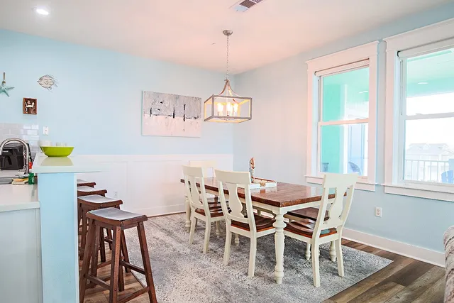 a view of a dining room with furniture and a window