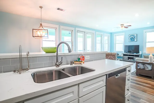a kitchen with a sink a counter top space and cabinets