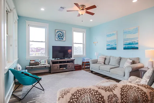 a living room with furniture and a flat screen tv