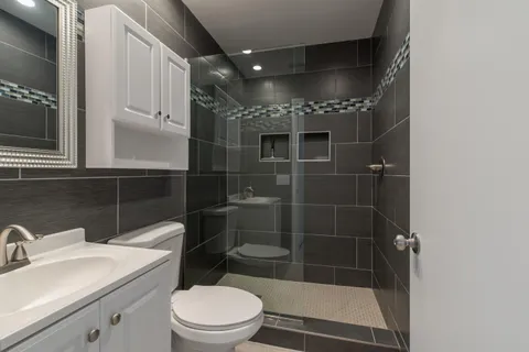 a bathroom with a toilet a sink and shower