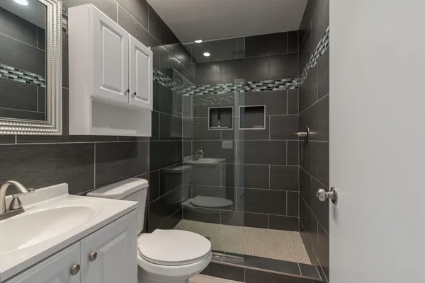 a bathroom with a toilet a sink and shower