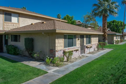 a front view of a house with garden and porch
