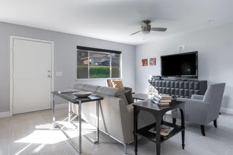 a work room with furniture and a flat screen tv