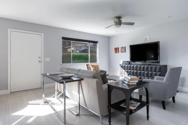 a work room with furniture and a flat screen tv