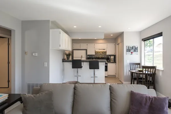 a living room with furniture and kitchen view