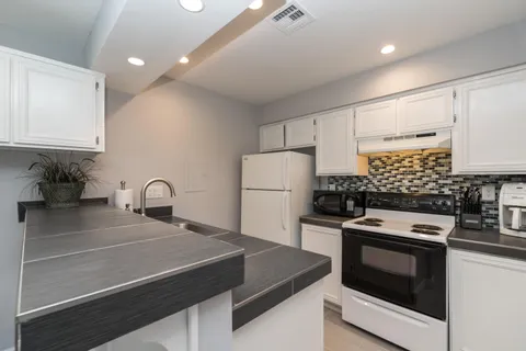 a kitchen with a sink a stove and refrigerator