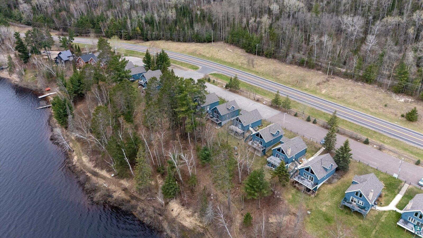 6266 Giants Ridge Road Biwabik, MN 55705 - Photo 4 of 37 Waterfront properties featuring a natural shoreline, mature trees, individual docks, and a paved access road