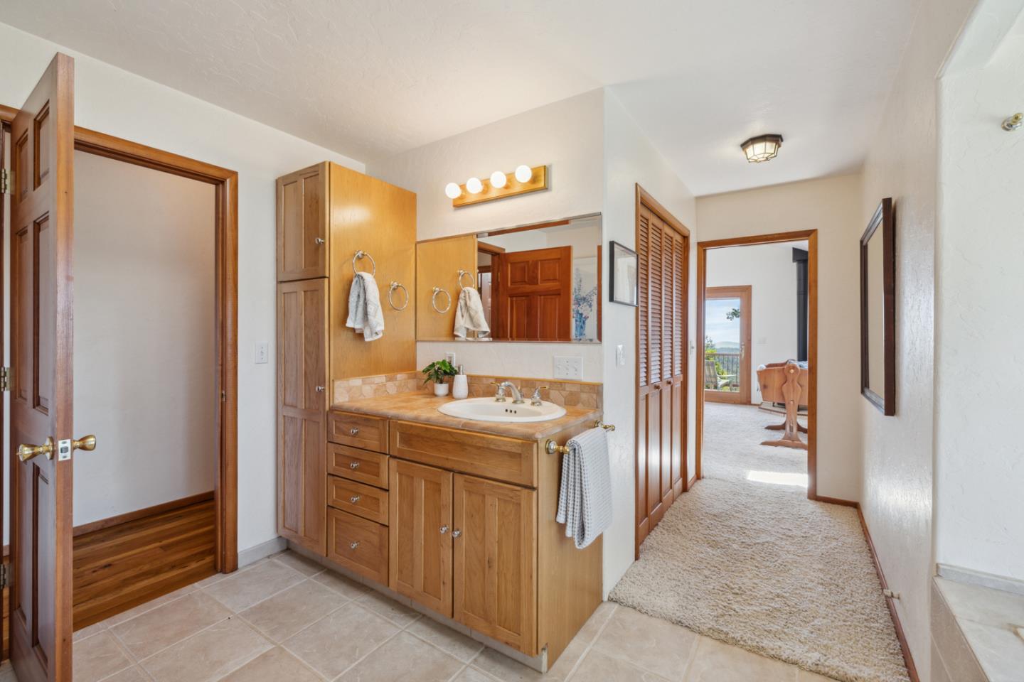 1495 Dons Road Boulder Creek, CA 95006 - Photo 13 of 40 a bathroom with a sink a mirror and a toilet