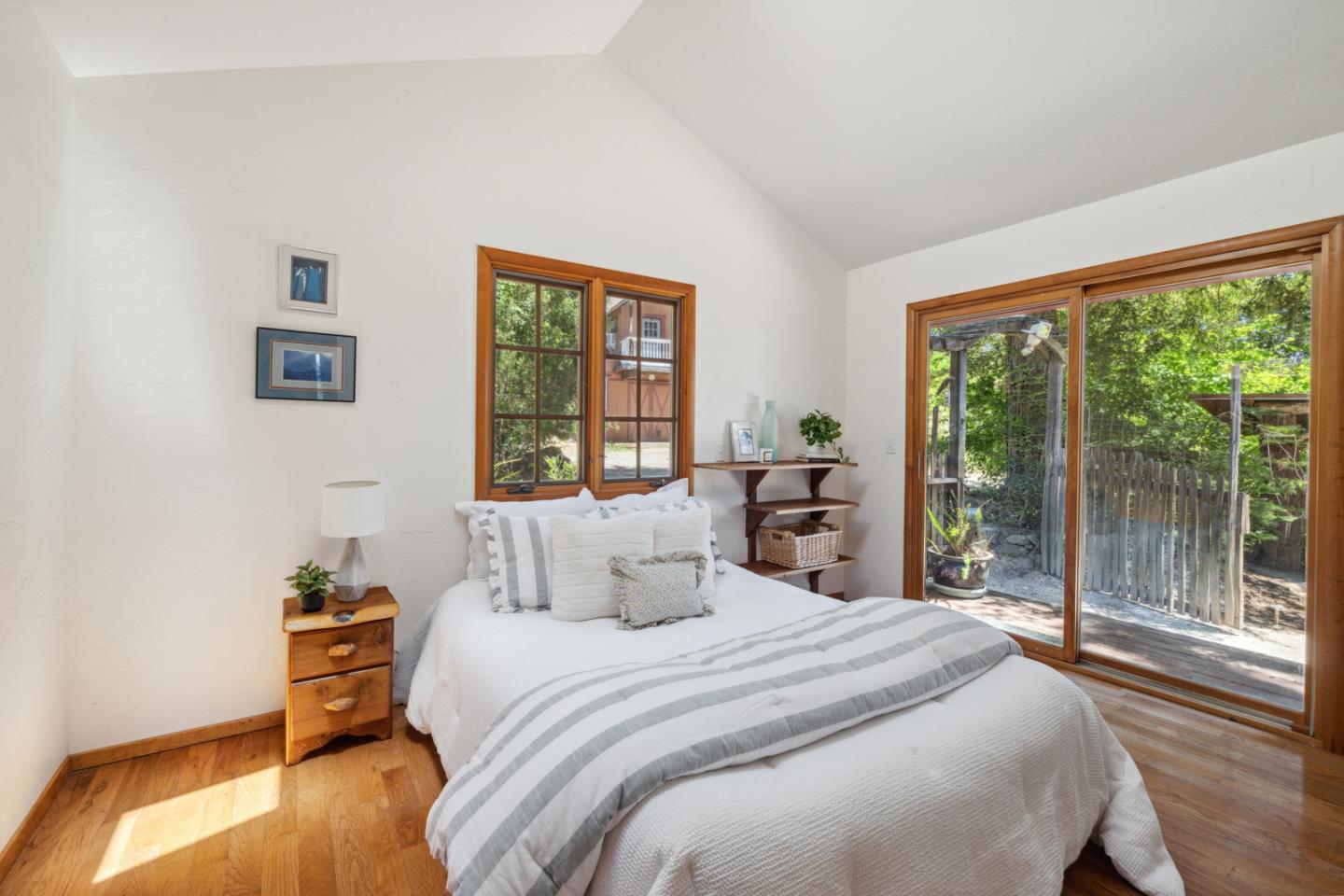 1495 Dons Road Boulder Creek, CA 95006 - Photo 18 of 40 a bedroom with a bed and a large window
