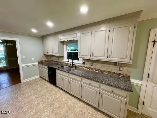 a kitchen with granite countertop a sink stainless steel appliances and cabinets