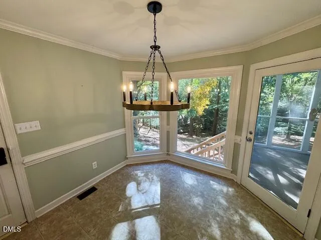 a view of a room with window wooden floor and front door