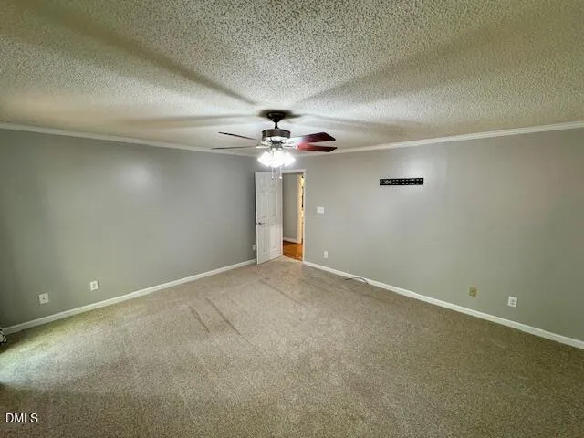 en empty room with a ceiling fan and window