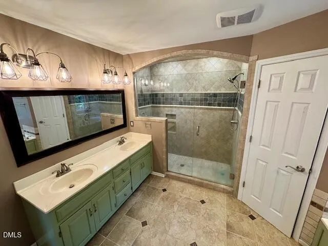 a bathroom with a sink a mirror and a shower