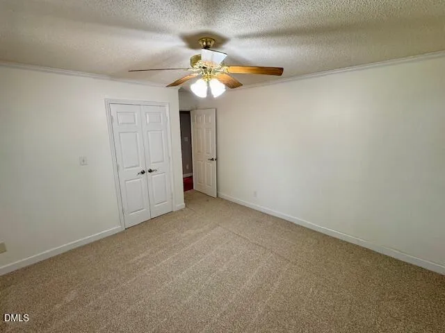an empty room with a chandelier fan and a chandelier fan