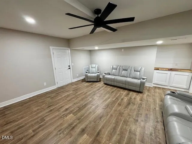 a living room with furniture and a ceiling fan
