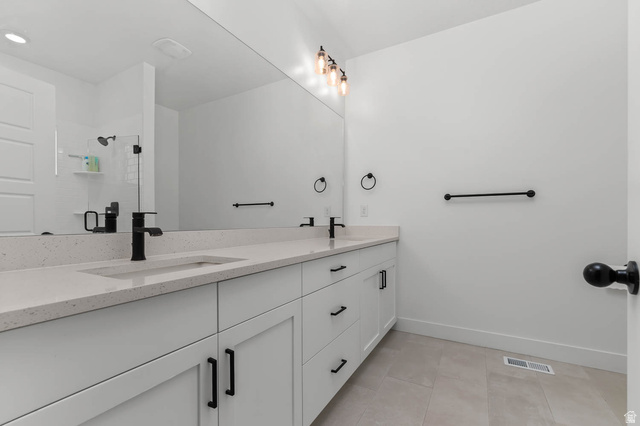 8307 Durham Street Sandy, UT 84070 - Photo 21 of 29 Dual vanity with light-toned countertop and integrated sinks, complemented by matte black fixtures and hardware