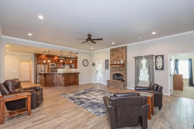 a living room with furniture a fireplace and a flat screen tv