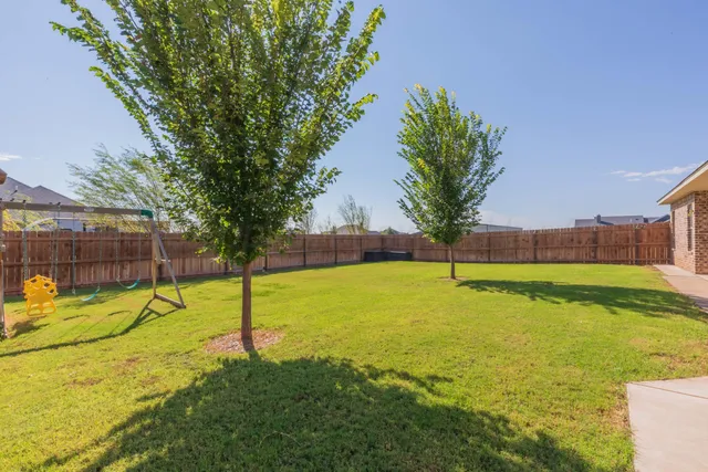 a view of a swimming pool with a yard