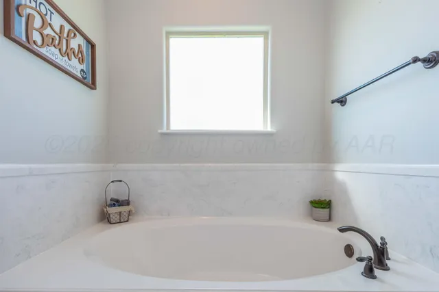 a white bath tub sitting in a bathroom